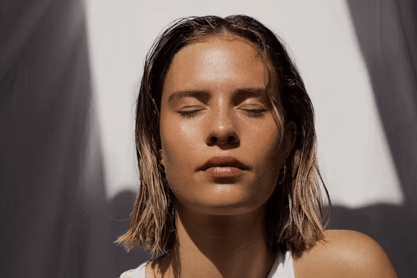 Femme aux yeux fermés embrassant l'éclat intérieur et la confiance
